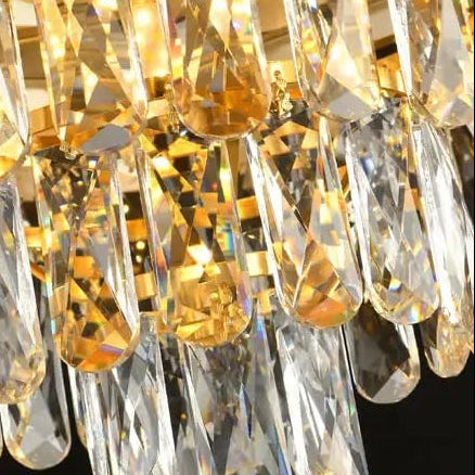 Close-up of cascading crystal chandelier drops with warm gold reflections