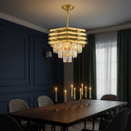 Gold stacked crystal chandelier above dining table with faceted hanging drops