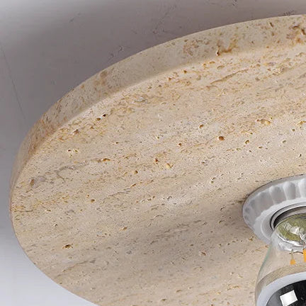 Travertine disc flush mount ceiling light close-up with chrome socket and bulb