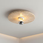 Round travertine disc flush mount ceiling light with chrome reflector and glowing bulb