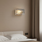 Rectangular ripple glass wall sconce with metallic gold-toned texture and metal mounting plate