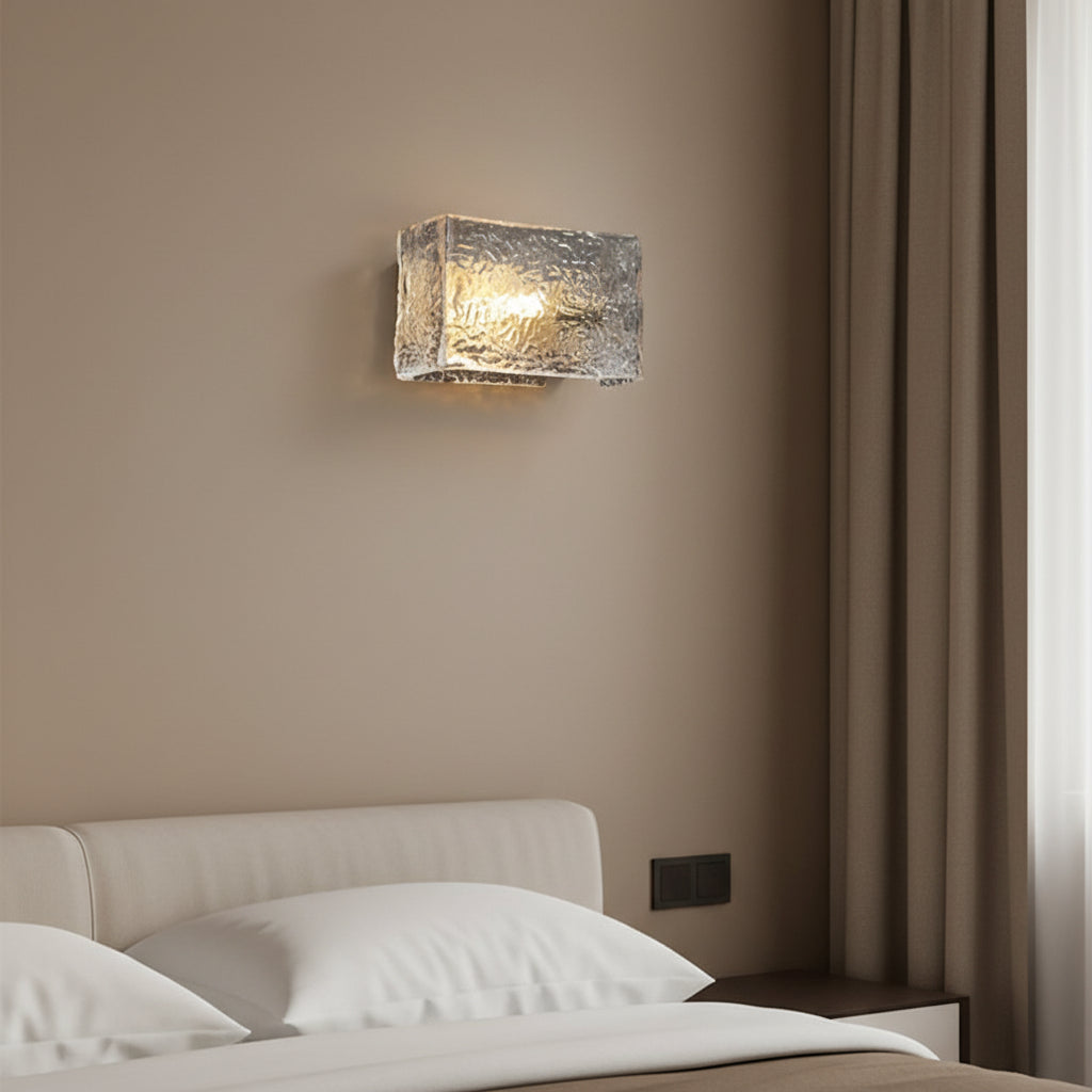 Rectangular ripple glass wall sconce with metallic gold-toned texture and metal mounting plate