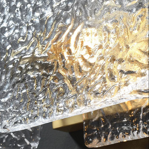 Close-up of rectangular ripple glass wall sconce with gold and silver textured glass panel