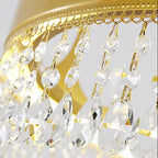 Crystal teardrop pendants hanging from a gold chandelier frame