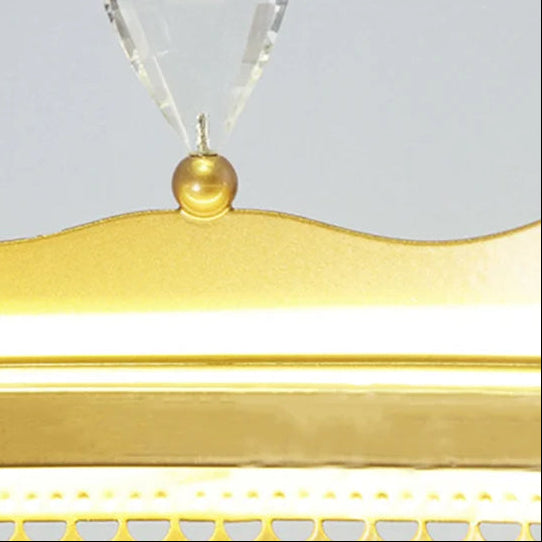 Gold top finial with clear crystal prisms on a chandelier shade
