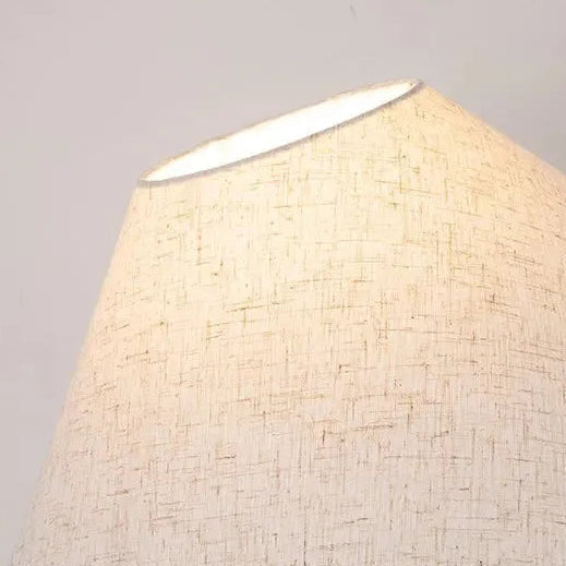 Close-up of conical light fabric lamp shade with textured woven pattern