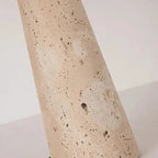Speckled travertine lamp pedestal base close-up with natural pits and marks