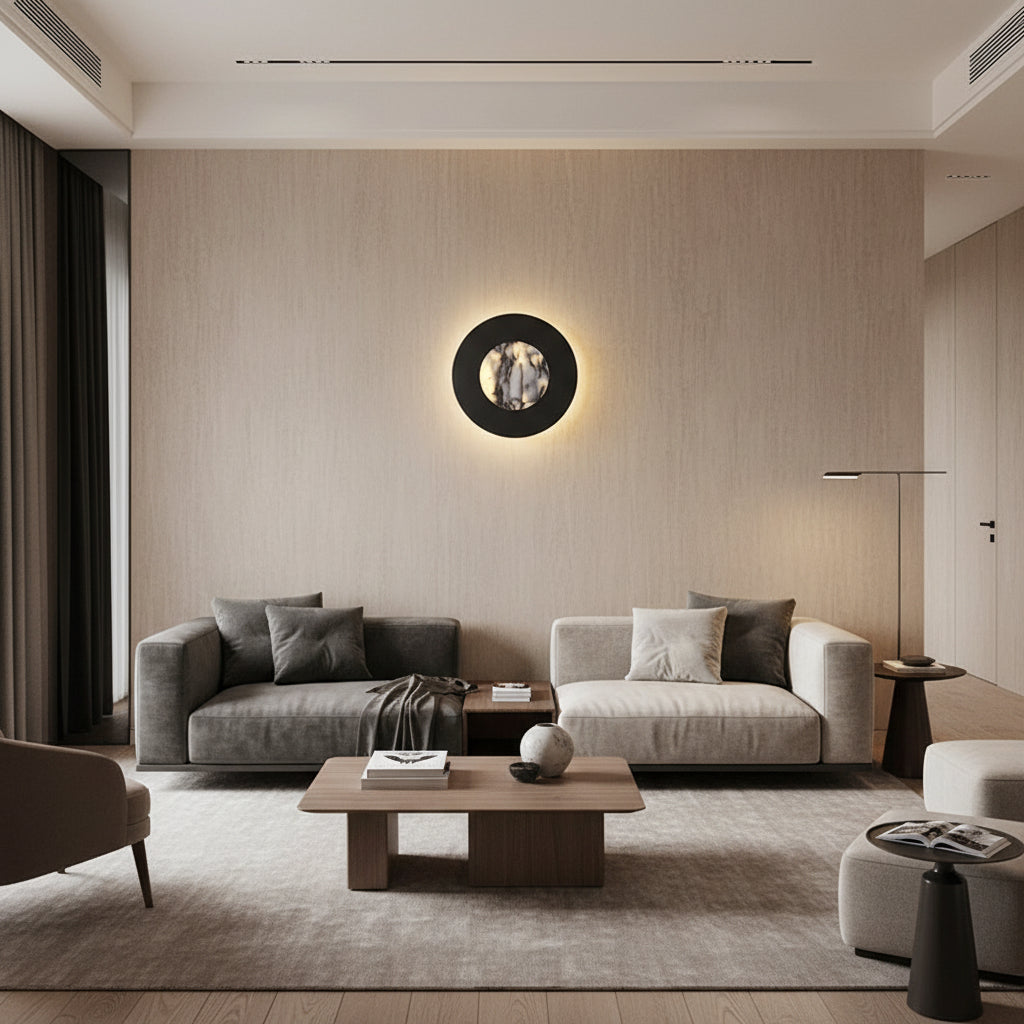 Round black backlit sconce with marble circular lens on wall