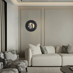 Round black wall sconce with backlit marble center and glowing halo