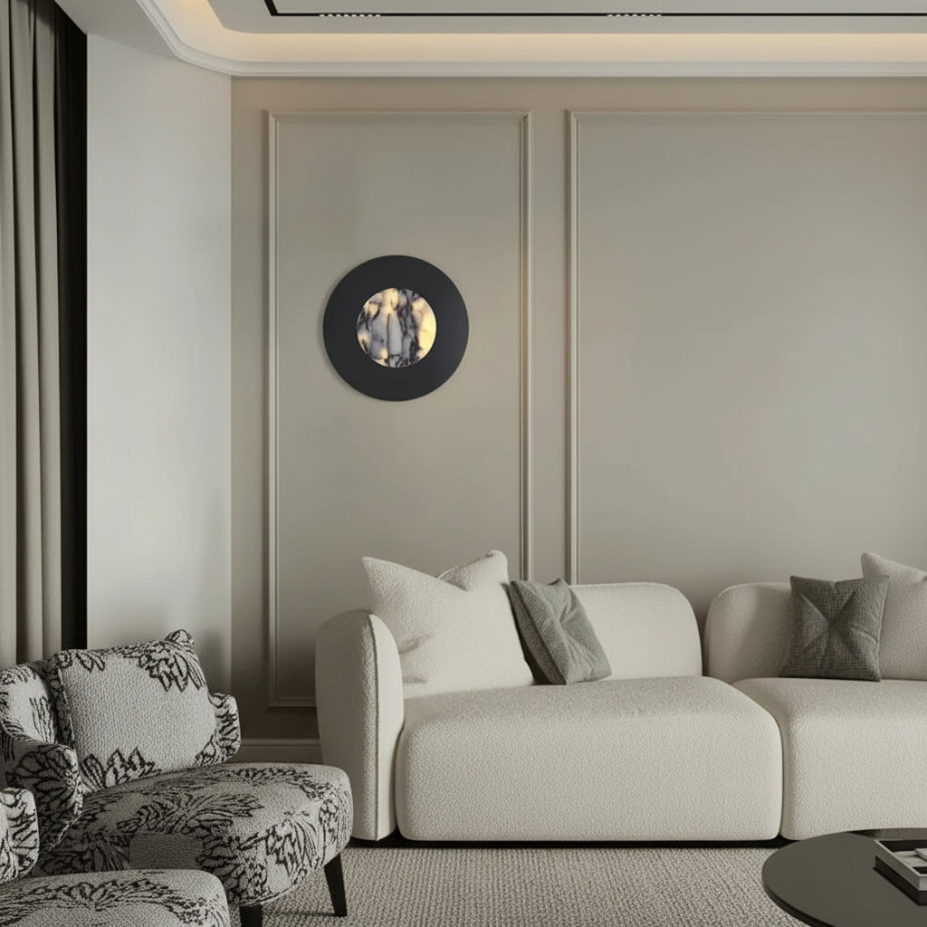 Round black wall sconce with backlit marble center and glowing halo