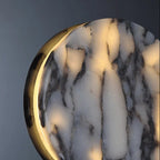 Close-up of round marble lens with black rim and gold edge glow