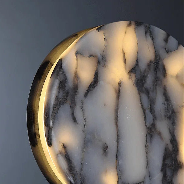 Close-up of round marble lens with black rim and gold edge glow