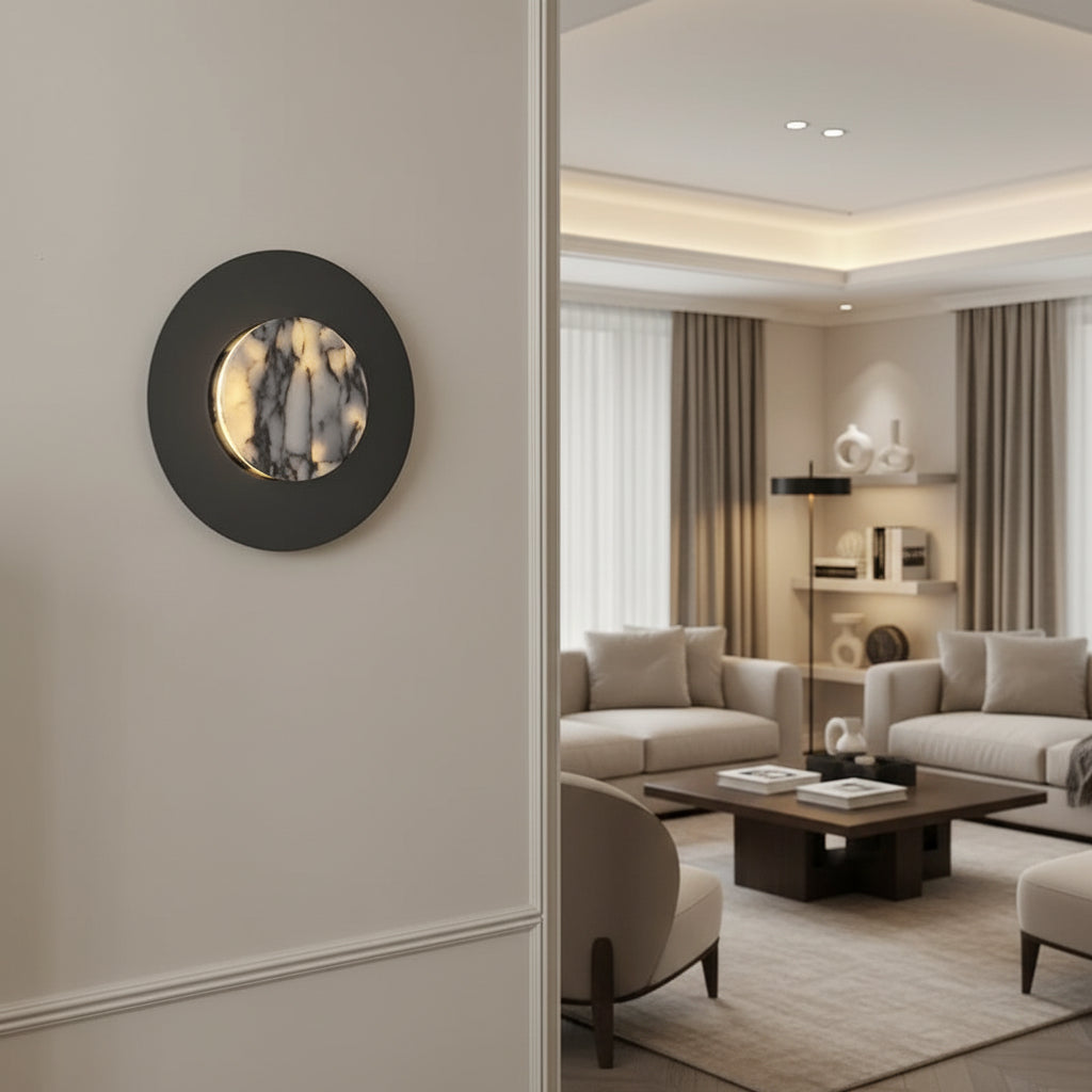 Round black wall sconce with backlit marble disk on interior wall