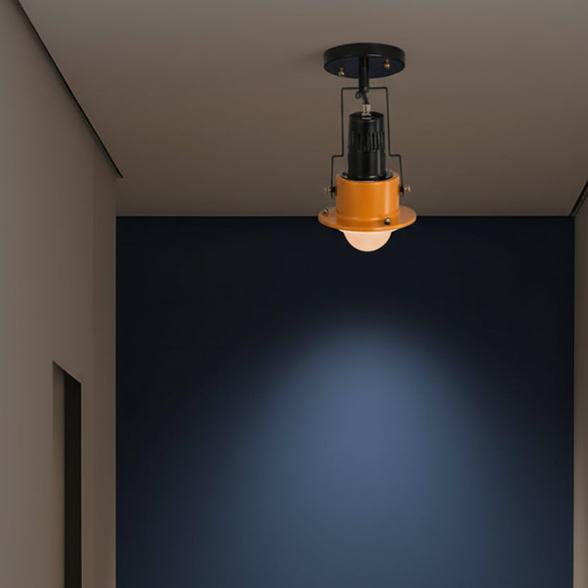 Black spotlight ceiling light with orange cup shade on a flush ceiling mount