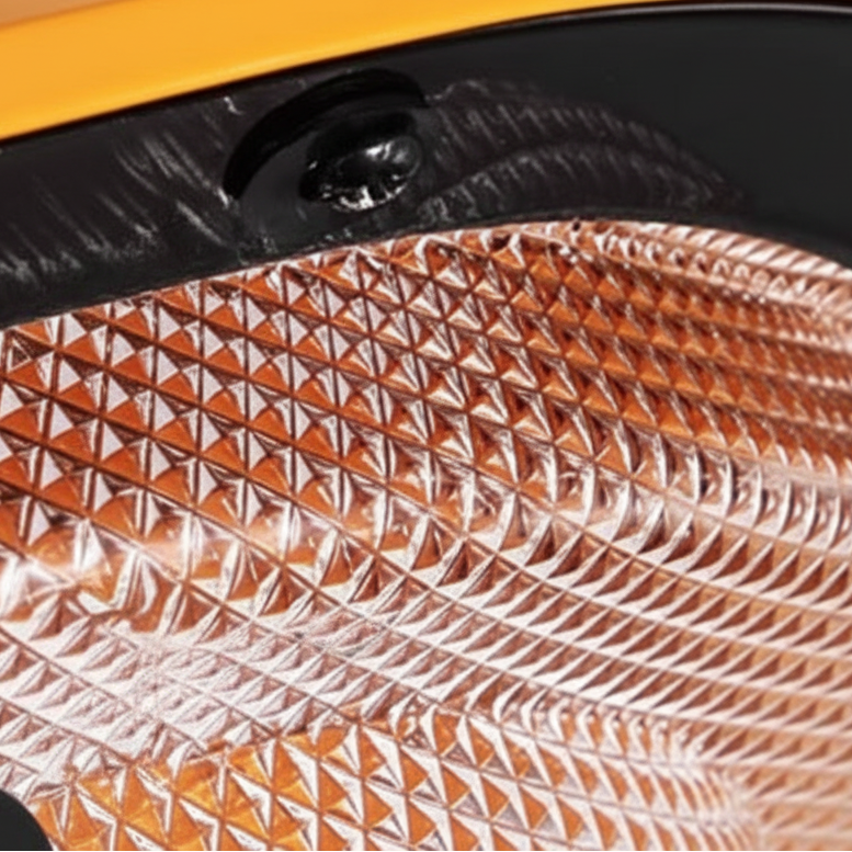 Orange and silver textured reflector inside a spotlight ceiling light