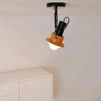 Adjustable black spotlight ceiling light with orange shade on a flush mount