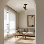 Adjustable spotlight ceiling light with black frame and orange shade