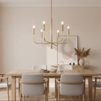 Gold candle-style chandelier with tubular arms and multiple lit candle bulbs