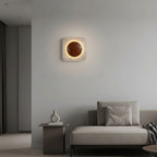 Square travertine backlit wall sconce with glowing circular center, warm light