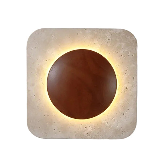 Travertine square wall sconce close-up: backlit circular opening with warm light