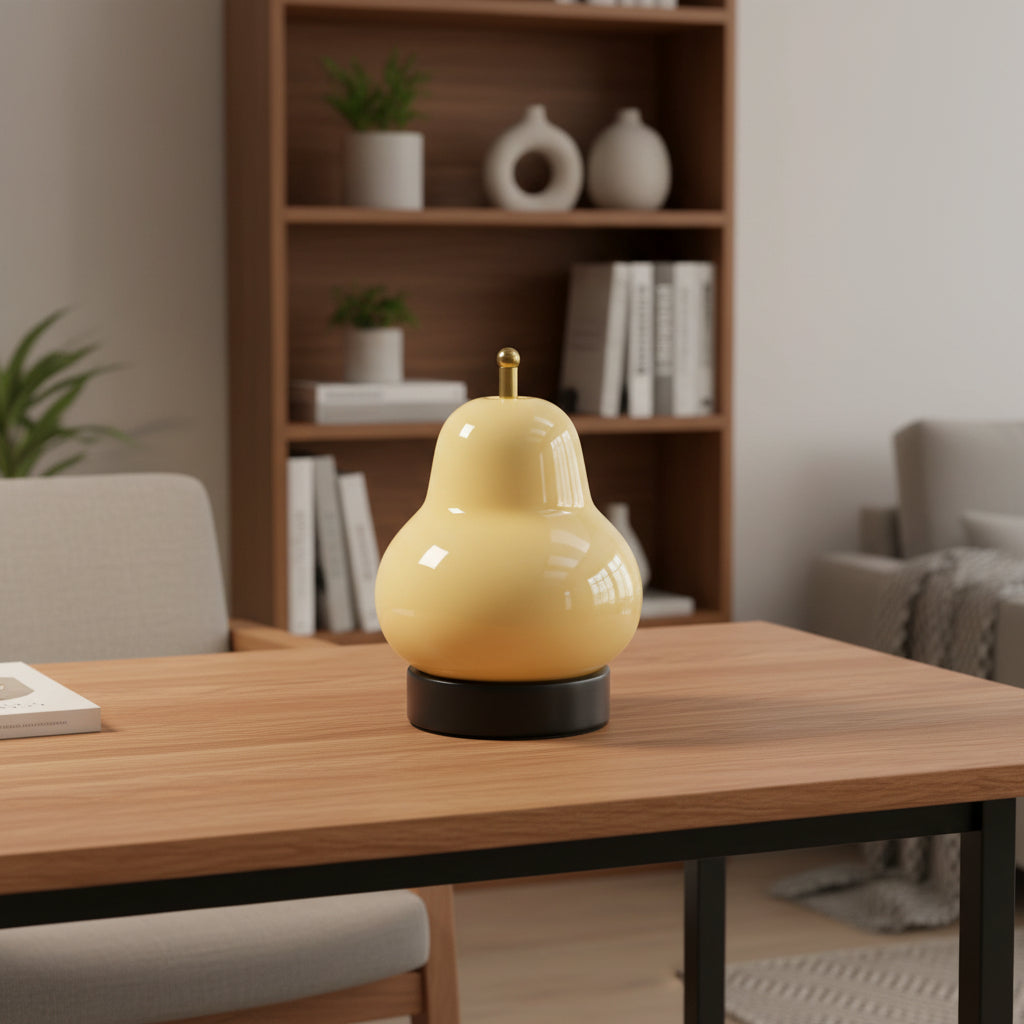 Cream gourd-shaped portable table lamp with gold top and black base.