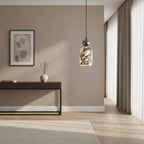 Single marbled glass pendant light with dark metal top, hanging above room seating.