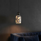 Marbled glass pendant light with warm yellow glow, dark metal top, centered on wall.