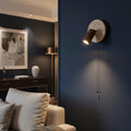 Wall spotlight sconce with round travertine disc, walnut cylinder shade, pull cord