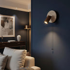 Wall spotlight sconce with round travertine disc, walnut cylinder shade, pull cord
