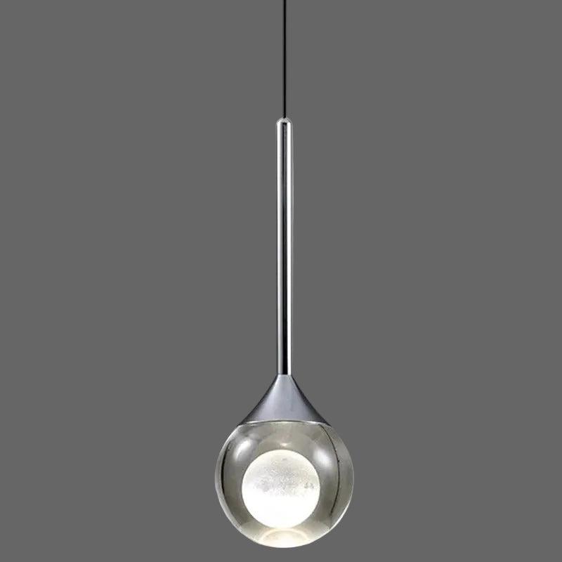 Single teardrop pendant light with reflective silver glass shade and bright circular inner glow