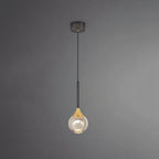 Teardrop pendant light with dark metal ceiling mount and warm glowing glass globe shade
