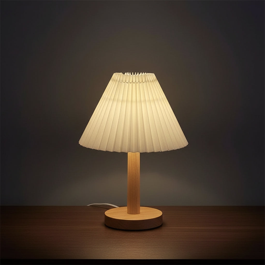 Pleated conical table lamp with cream shade and light wood round base