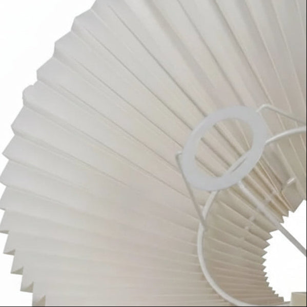 Close-up of white pleated conical lamp shade with metal harp detail