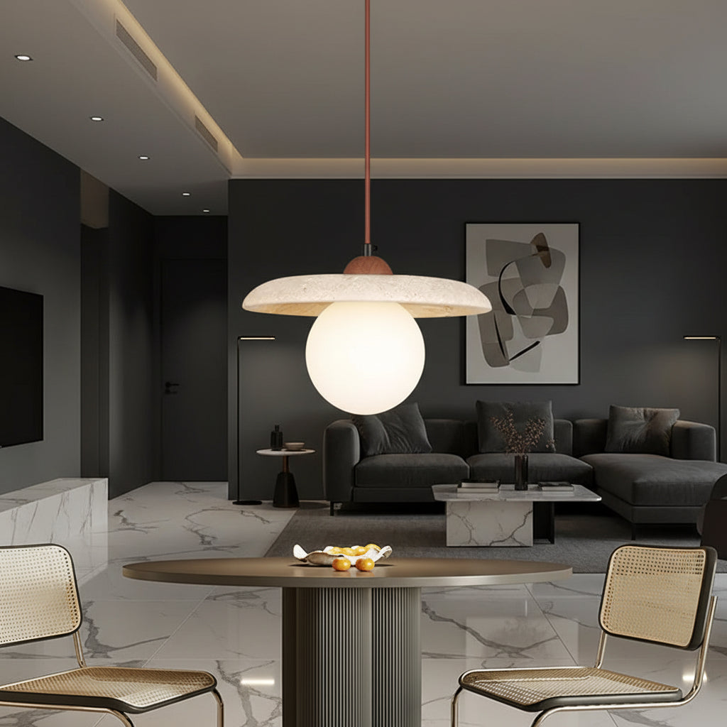 Globe pendant light hanging on a red cord, speckled travertine disc and off-white globe