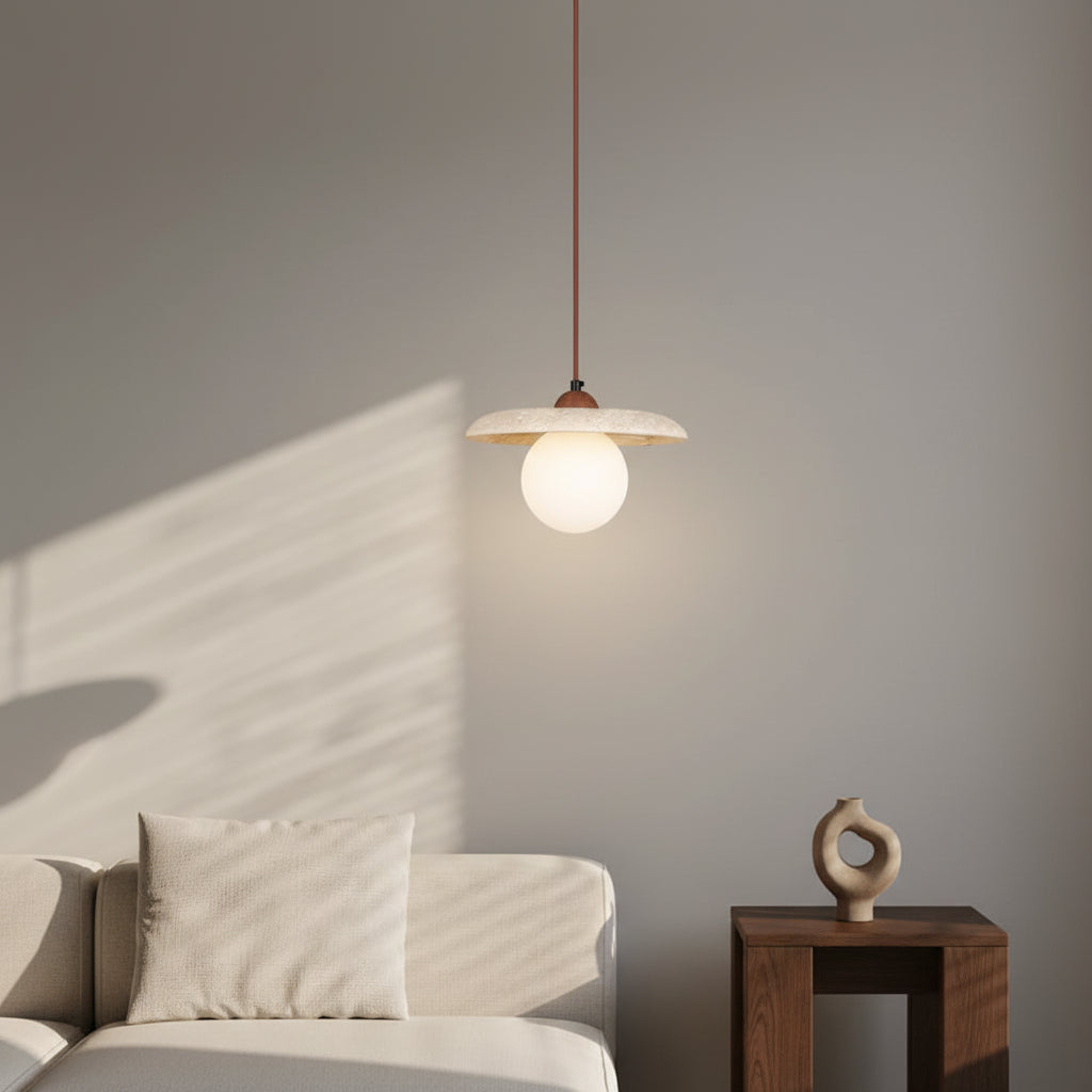 Globe pendant light with off-white glass bulb and speckled travertine disc shade