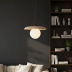 Single globe pendant light with speckled travertine shade and round off-white bulb