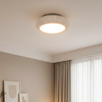 Round flush mount ceiling light with textured speckled stone shade and warm glow