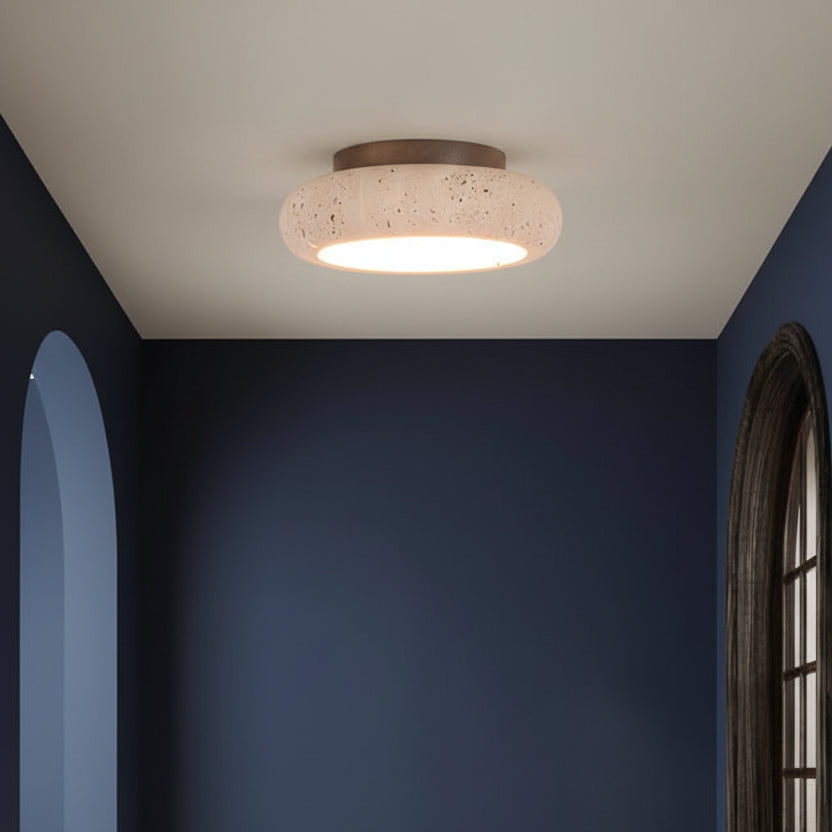 Round flush mount ceiling light with speckled travertine shade and warm light glow