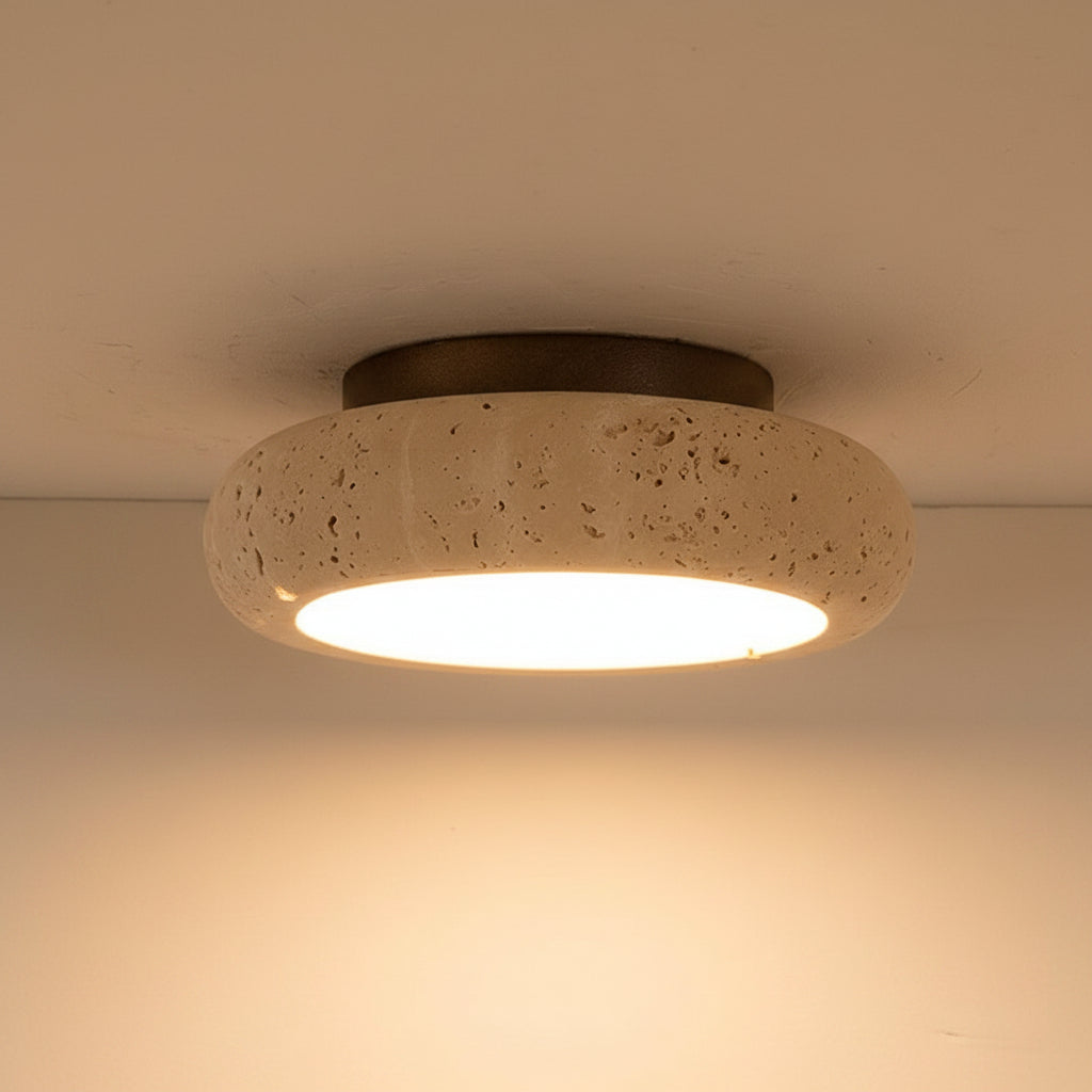 Round travertine ceiling flush mount light with speckled stone shade and warm glow