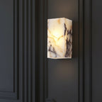 Rectangular marble wall sconce fixture emitting warm light