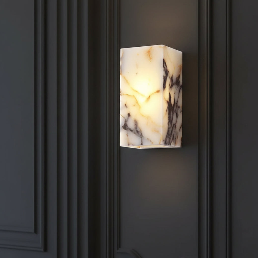 Rectangular marble wall sconce fixture emitting warm light