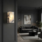 Rectangular marble wall light sconce installed in a living room, warm glow