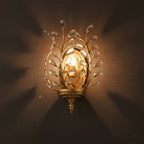 Gold botanical crystal branch wall sconce with warm glow and faceted clear ornaments