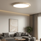 Round flush mount ceiling light with travertine-style ring and bright circular diffuser
