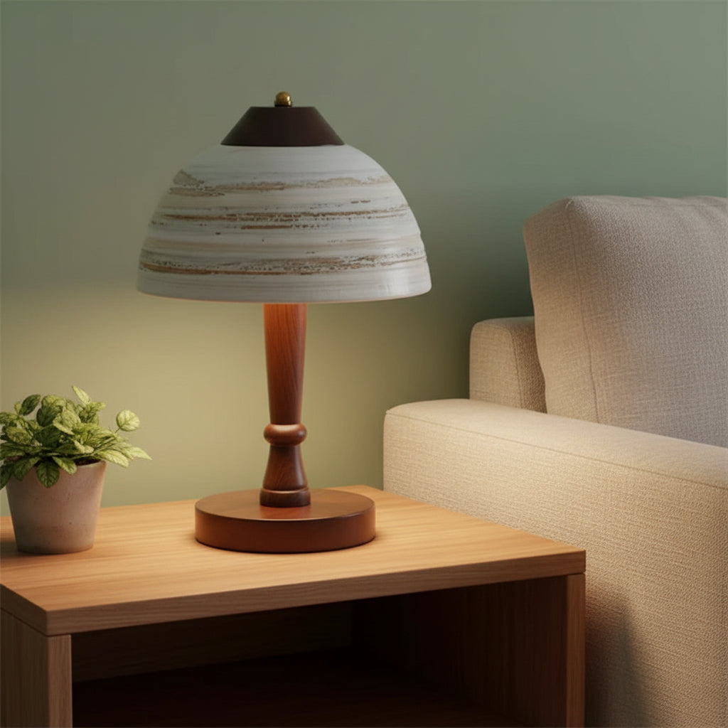 Ceramic mushroom table lamp with striped dome shade and dark wood pedestal on tabletop