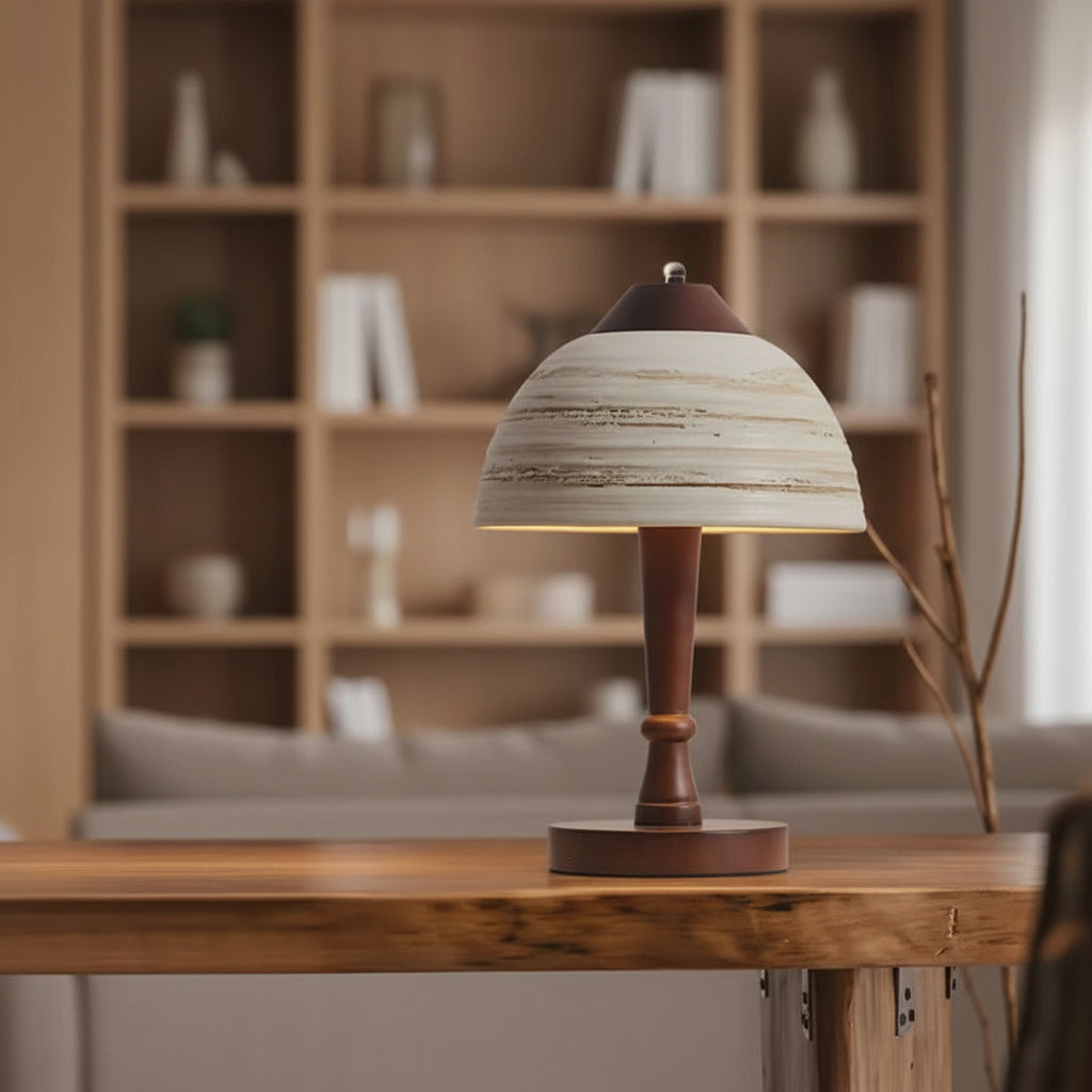 Ceramic dome table lamp with striped mushroom shade on wooden surface in living room