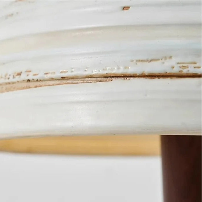 Close-up of striped ceramic lampshade rim with worn speckled finish